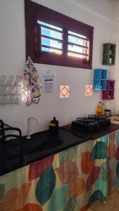 a kitchen with a counter top with a sink at Pousada Preguiça in Canoa Quebrada +38 photos