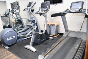 a gym with three exercise bikes and a treadmill at Baymont Inn And Suites by Wyndham Platteville in Platteville