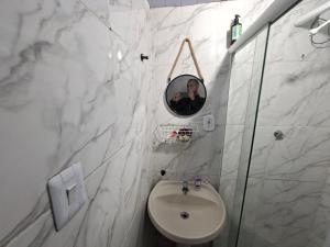 a man taking a picture of a bathroom with a sink at Casa de Férias Carioca in Rio de Janeiro +29 photos