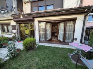 a house with a purple table in the yard at Safely located apartment in Prishtinë