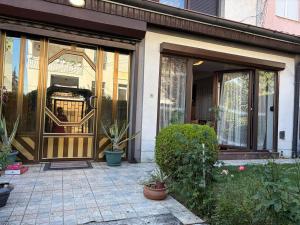 an entrance to a house with a glass door at Safely located apartment in Prishtinë +7 photos