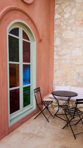 two chairs and a table next to a window at Casa Mediterraneo Hotel in Meyisti +92 photos