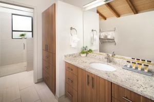 a bathroom with a sink and a mirror at Nama-Stay Retreat Village in Springdale