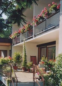 a building with a bunch of potted plants on the balconies at Gästehaus Kuchernig in Völkermarkt