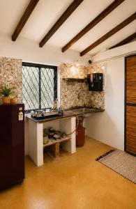 a kitchen with a sink and a counter in a room at Lax Stays Morjim by SevenTales in Morjim