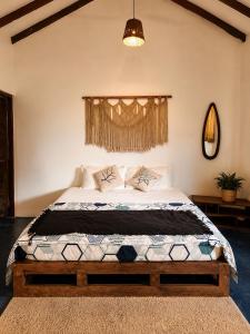 a bedroom with a large bed in a room at Lax Stays Morjim by SevenTales in Morjim
