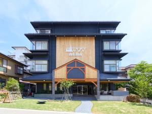 a building with a sign on the front of it at mt. inn(マウントイン） in Nihommatsu