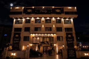 a building with lights on top of it at night at Antalya Hotel Am in Amman