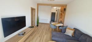 a living room with a couch and a table at Forest Nest - Livezeni in Livezeni