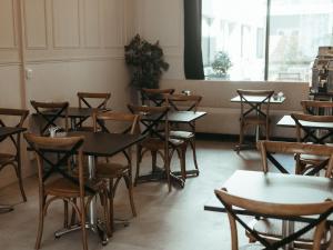 a row of tables and chairs in a restaurant at Hotel de Paris in La Rochelle +46 photos