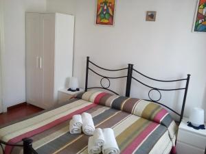 a bedroom with a bed with white slippers on it at B&B La Cubanina in Rome