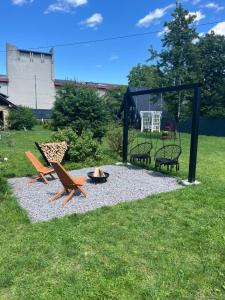 a group of chairs and a fire pit in the grass at Сколе Серце Карпат in Skole