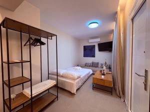 a bedroom with a bed and a book shelf at Annasa Suites 2 in Mángana