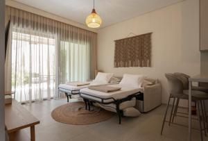 a living room with two beds and a couch at DARION Residence in Nikiti