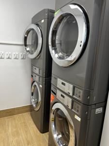 two washing machines are next to each other in a laundry room at Bi Apartments in KoÅ¡ickÃ© KÃºpele
