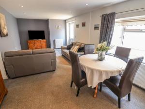 a living room with a table and a couch at Number 3 Old Boston Road in Lincoln