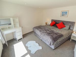 a bedroom with a bed and a desk and a television at Number 3 Old Boston Road in Lincoln