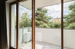 a view from the balcony of a house with sliding glass doors at Warsaw Concierge Gocławek in Warsaw +8 photos