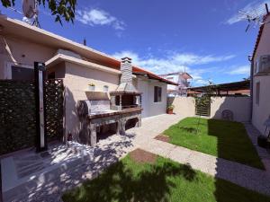 a backyard of a house with a grill at Annasa Suites 1 in Mángana