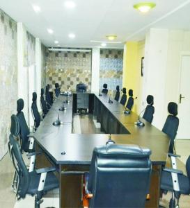 a large conference room with a long table and chairs at Andysilk Resort International in Ozu Abam