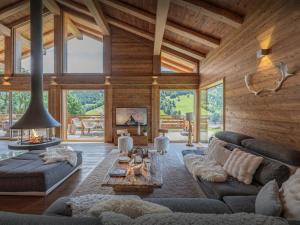 a living room with a couch and a table at Chalet Alti - OVO Network in Le Grand-Bornand