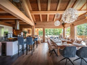 a kitchen and dining room with a table and chairs at Chalet Alti - OVO Network in Le Grand-Bornand