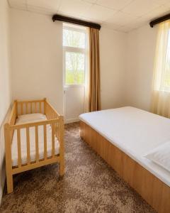 a bedroom with two beds and a window at Sochi Resort-Pine Garden Boutique Hotel and Pool Stepanavan in Stepʼanavan