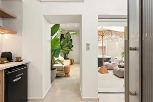 a kitchen and living room with a view of a living room at Asikiko Suites in Rethymno