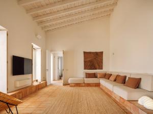 a living room with a couch and a flat screen tv at Casa Dez - Pedrogão do Alentejo in Pedrógão