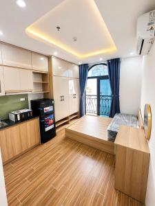 a living room with a bed and a kitchen at Happy Hotel Phu Tho 