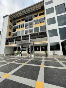 an empty parking lot in front of a building at Andysilk Resort International in Ozu Abam