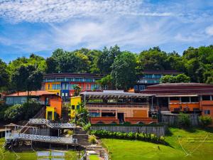 a group of buildings with trees in the background at Raya Buri Resort Kanchanaburi in Ban Hin Hak