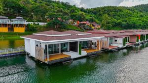 a house on a dock in the water at Raya Buri Resort Kanchanaburi in Ban Hin Hak