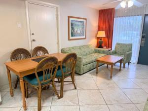 a living room with a table and chairs and a couch at Lifetime of Vacations in Orlando