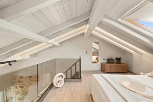 a bedroom with white ceilings and a bed at Asikiko Suites in Rethymno