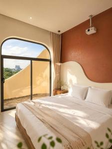 a bedroom with a large bed and a large window at Shine Home in Hue +44 photos