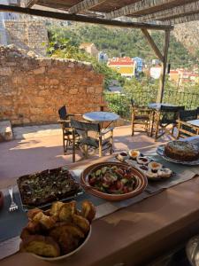 a table with many different types of food on it at Casa Mediterraneo Hotel in Meyisti