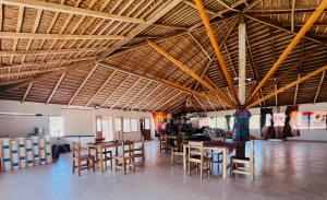 a dining room with tables and chairs in a building at Timonier Ecolodge in Mar Lodj