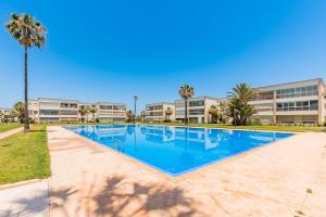 a large swimming pool in front of a building at Ola Blanca - Pool - Garden in Dar Hamida