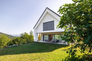 a house with a view of a yard at Balsamia Boutique Apartments in Podčetrtek