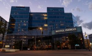 a large building with a hotel indigo sign in front at Hotel Indigo Denver Downtown - Union Station by IHG in Denver