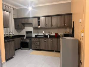 a large kitchen with wooden cabinets and appliances at Mallony Homes in Kampala