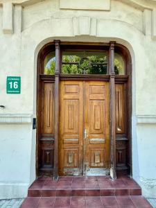 a wooden door in a building with a sign on it at Apartament Verde Stare Miasto in Chełm +1 photo