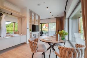 a kitchen and dining room with a table and chairs at Balsamia Boutique Apartments in Podčetrtek