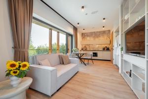 a living room with a couch and a table at Balsamia Boutique Apartments in Podčetrtek