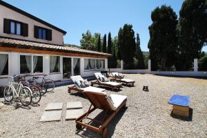 a patio with chairs and bikes in front of a house at Villa Silvia direttamente sul mare in Caronia Marina