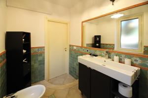 a bathroom with a sink and a mirror at Villa Silvia direttamente sul mare in Caronia Marina +28 photos