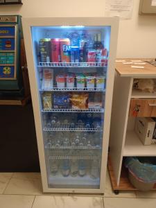 a refrigerator filled with lots of water and drinks at VillaGioveRooms in Prato +13 photos