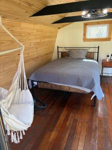 a bedroom with a hammock in a cabin at Cozy Bethel Barn in Mongaup Valley