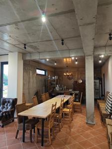 a dining room with a large wooden table and chairs at Hotel Manglisi Hills in Manglisi